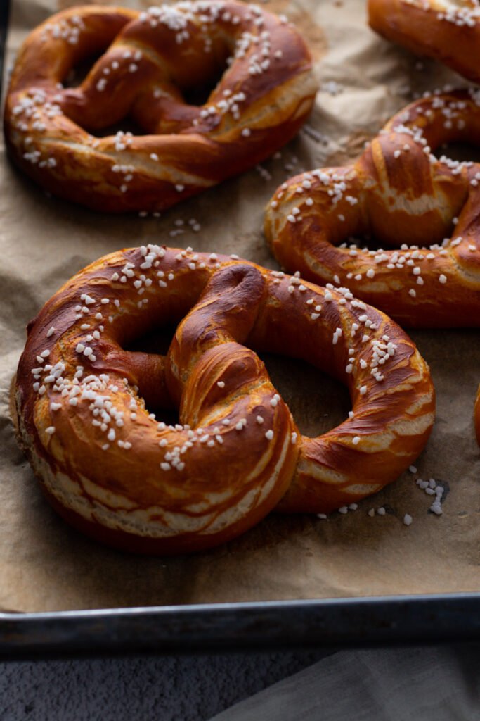 Bavarian pretzels on a baking tray.