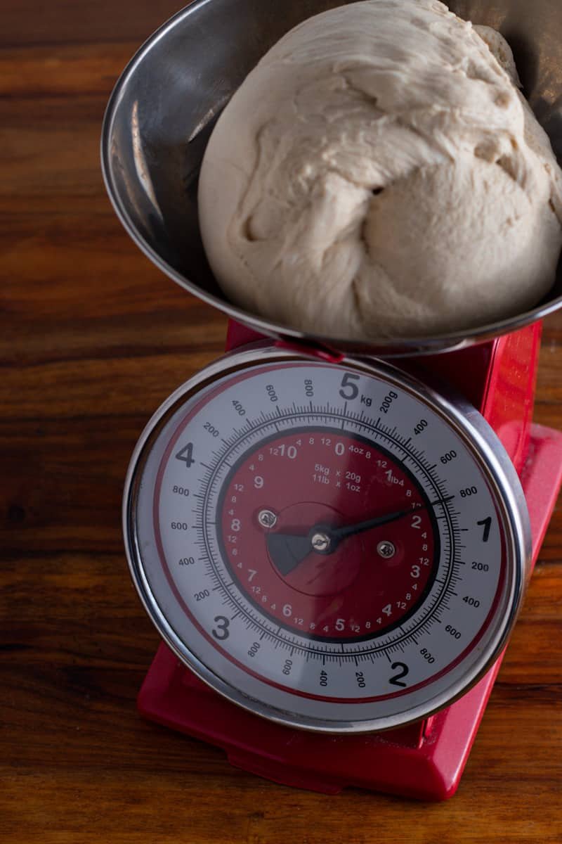 Pretzel dough weighing 800 grams in a scale.