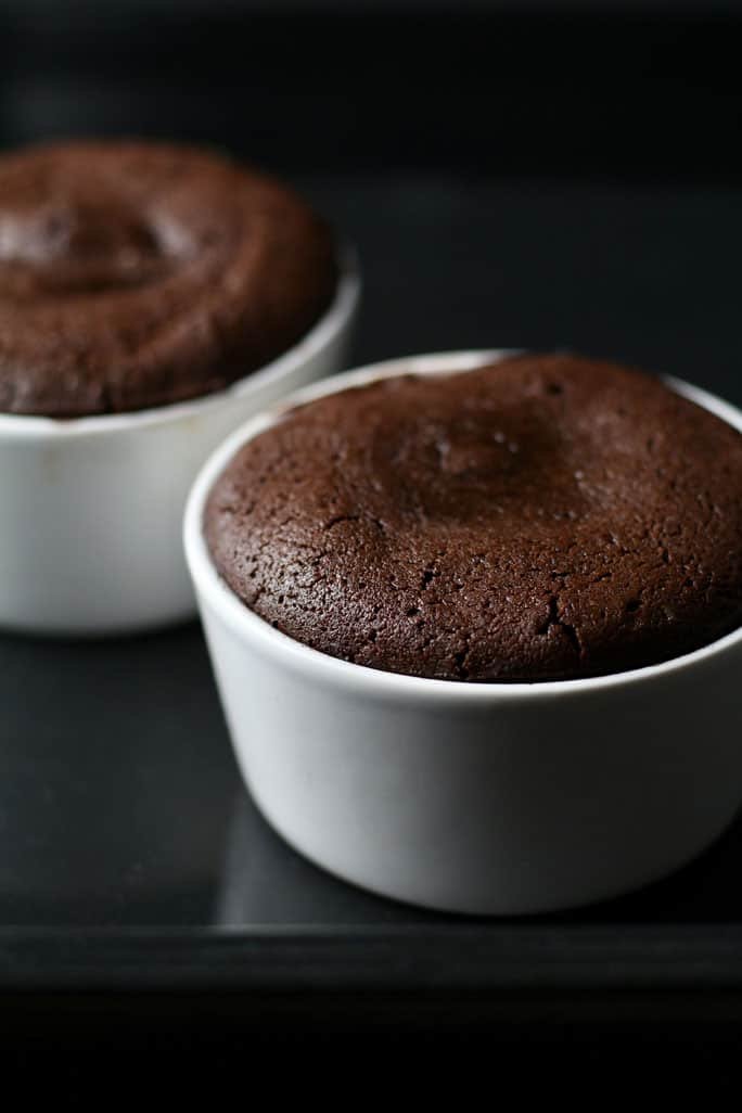 Freshly baked and risen Chocolate Lava Cakes showing a perfect dimple in the middle.