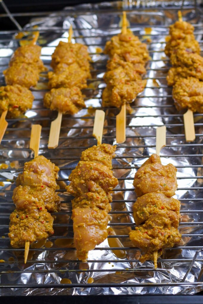 Marinated Satay Chicken on skewers ready to be grilled