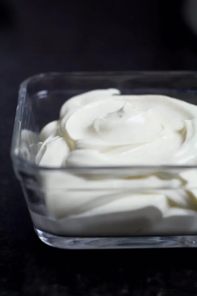 Homemade Cream Cheese in a glass container.