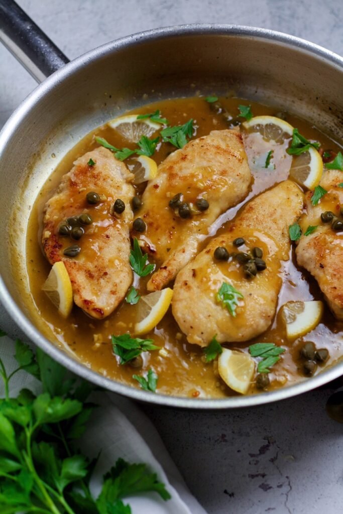 Lemon and Caper Chicken Piccata with tender chicken breasts in a light and tangy lemon sauce.