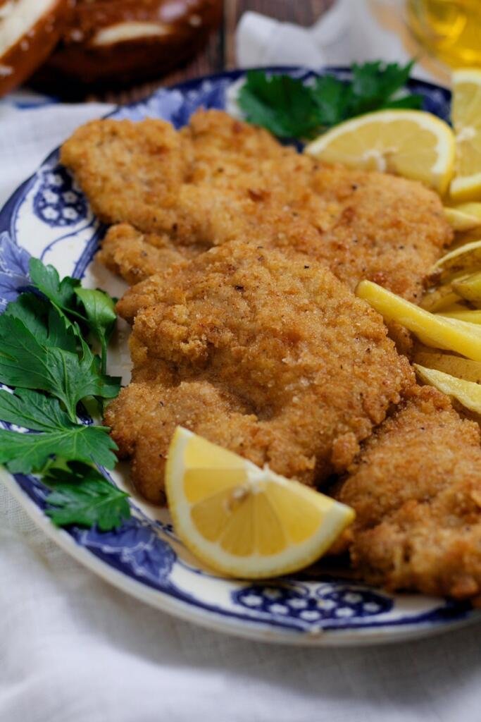 Bavarian Pork Schnitzel with french fries on a plate.
