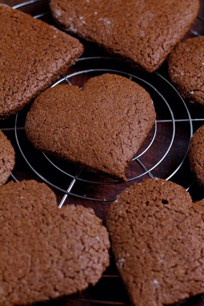 Baked but undecorated gingerbread hearts.