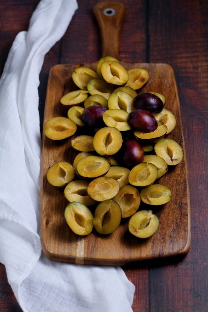Zwetschgen or prune plums sliced on a chopping board 