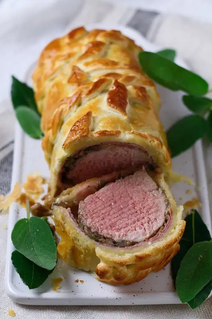Juicy, perfectly cooked pork tenderloin, wrapped in prosciutto, mushrooms and buttery puff pastry. This is truly the Perfect Pork Wellington, my dinner party secret weapon. Better yet, it is even easier to make than it looks!