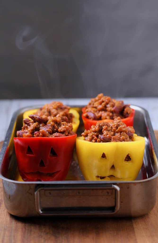 Uncooked jack o lantern peppers filled with beef chili.