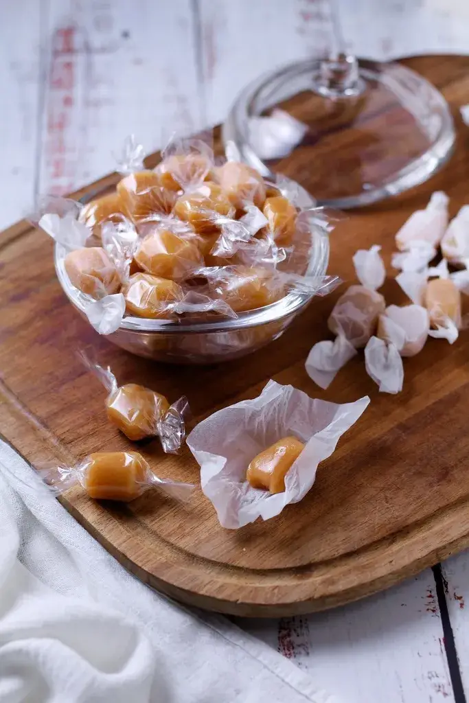 Honey Vanilla caramels in a bowl and on a board.