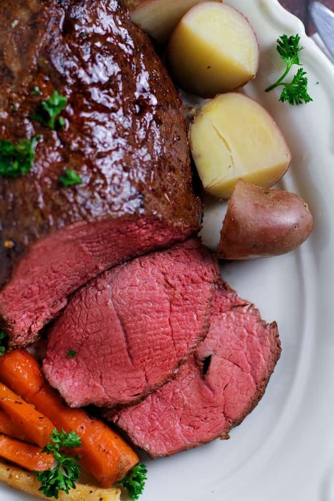 Perfectly tender, rosy roast beef is easier than you think! Slow Roast Beef where the beef is seared before roasting at a very low temperature produces juicy, delicious beef every time.