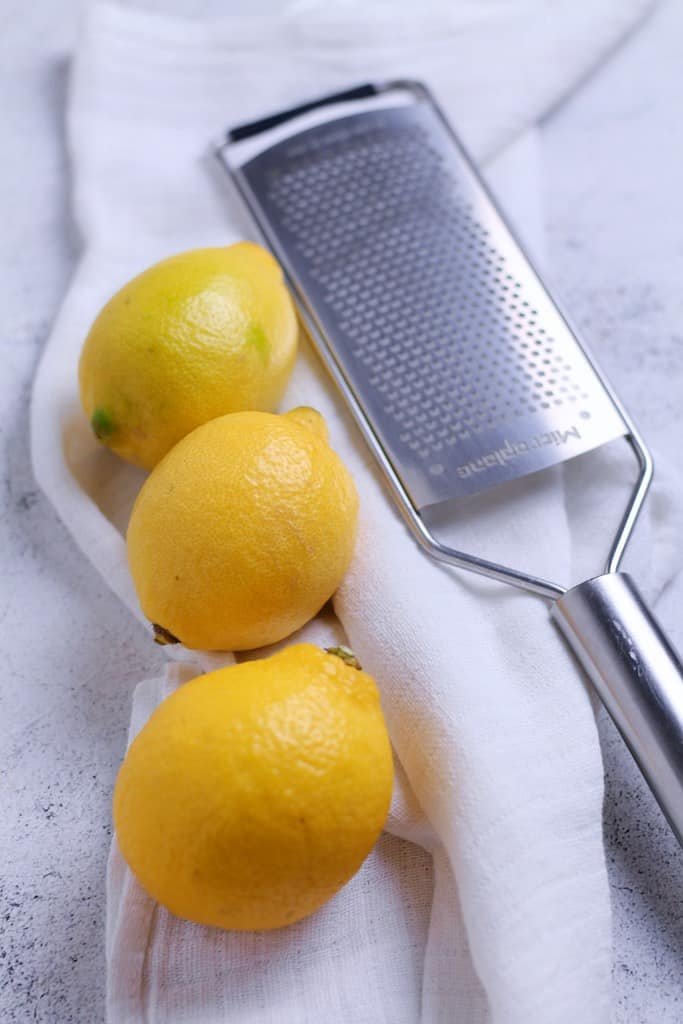Three lemons and a microplane grater.