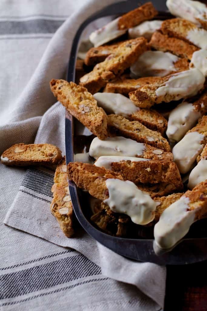 A tray of white chocolate dipped, apricot and almond biscotti on a tray.