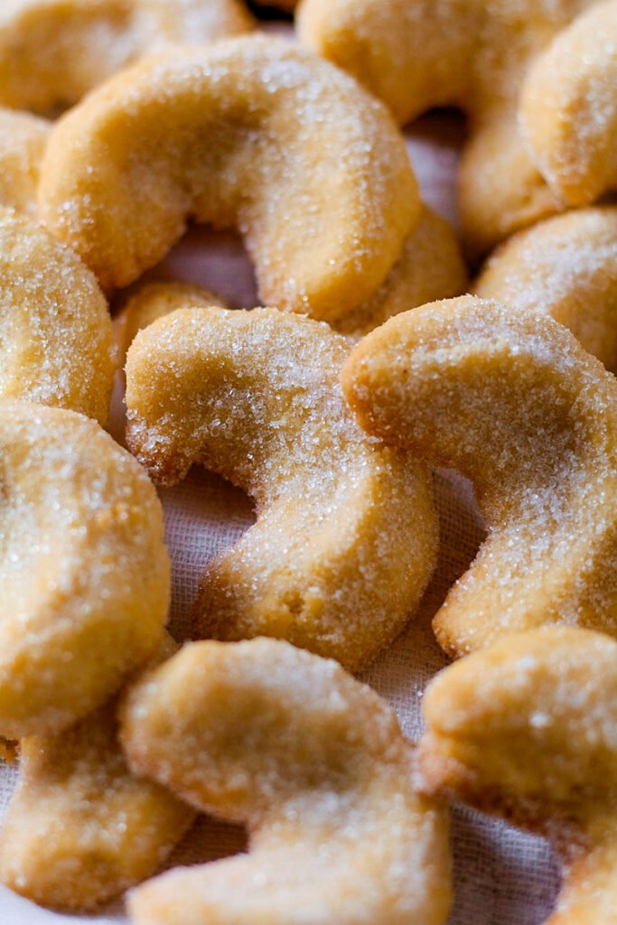 A close up photograph of baked Vanillekipferl cookies.