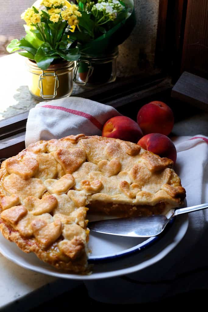 Peach and Ginger Pie is the perfect bake for those long, lazy, late summer days when the trees are full of ripe, juicy fruit. Perfect for taking on a picnic, or serving for dessert. I like to get started with making the pastry as soon as I get up, while the kitchen is still cool.