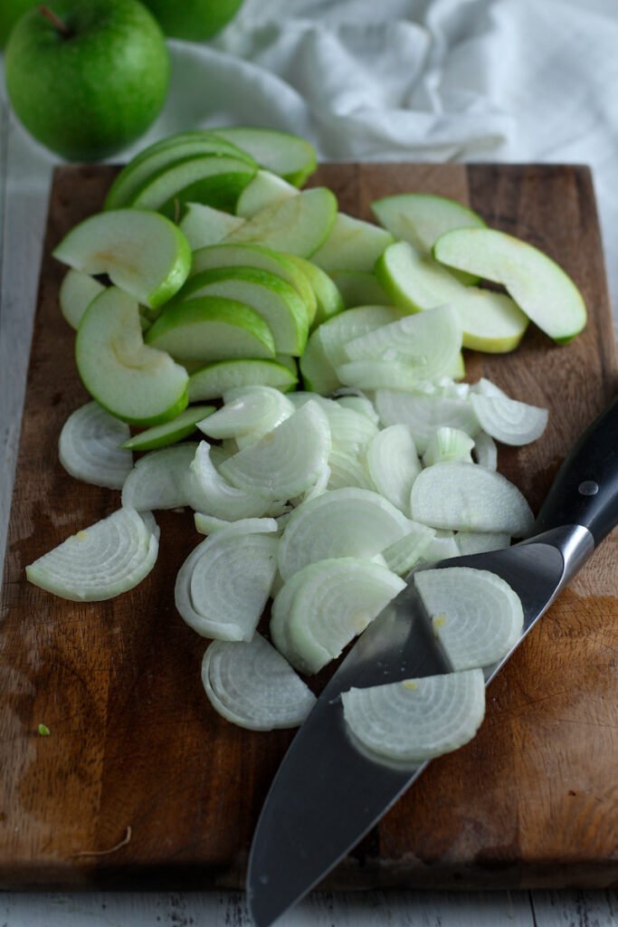 Chopped apple and onion for devilled sausages.