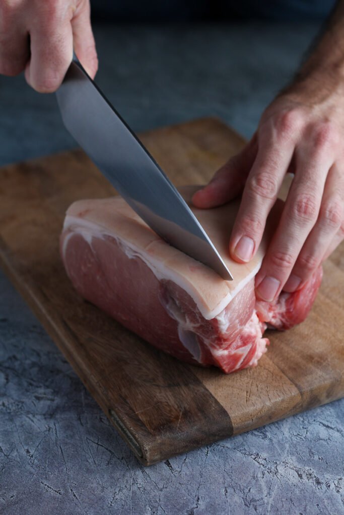 Scoring the skin of a pork roast