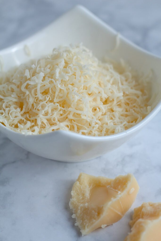 Grated Parmesan cheese in a white bowl
