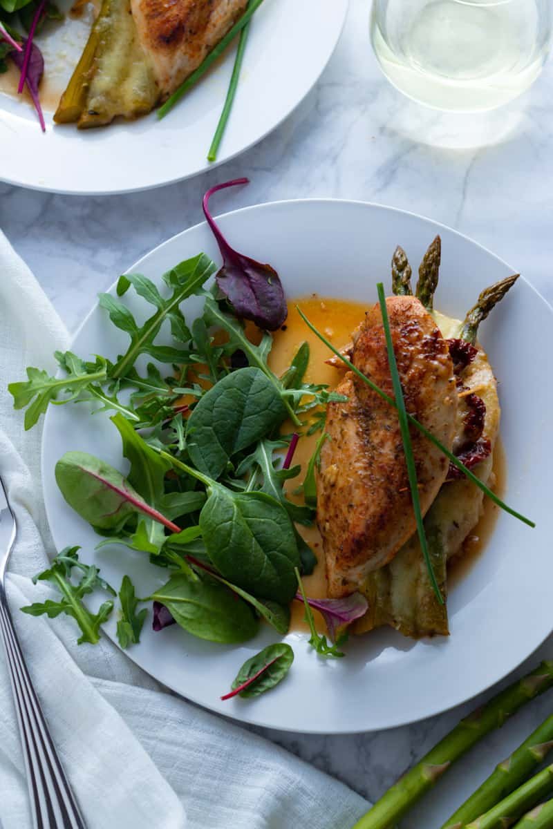 An easy-breezy dinner for springtime, Asparagus Stuffed Chicken Breasts are simple to prepare but look and taste fabulous. This is a brilliant recipe for an easy dinner party or Easter lunch.