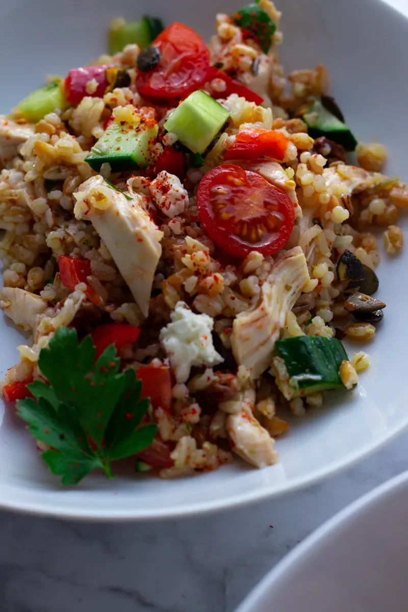 Chicken and Farro Salad with tomatoes, cucumber, peppers and feta.