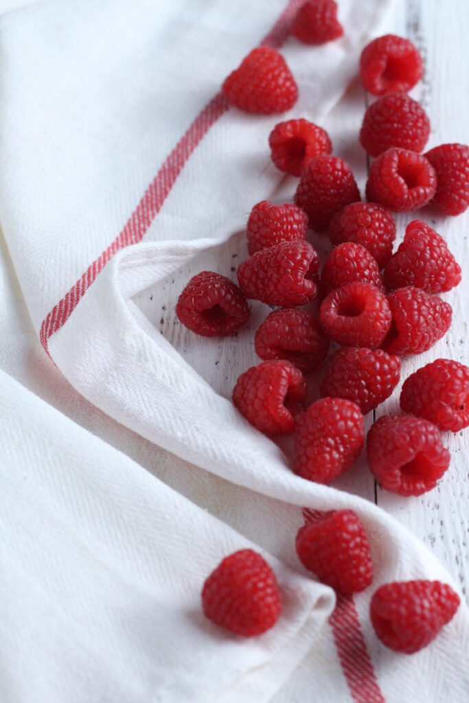 Fresh raspberries on a white cloth