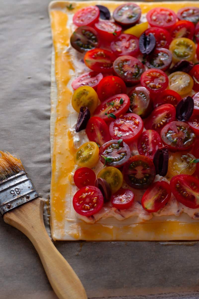 Cherry Tomato Tart with egg was and a pastry brush