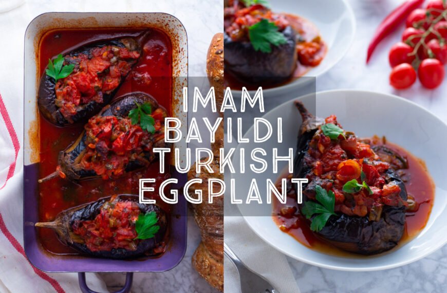 A picture of Imam Bayildi, roast Turkish eggplants stuffed with tomatoes and onions in a white bowl