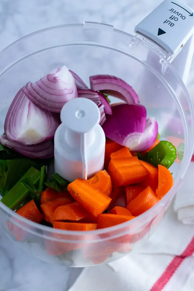 Red onions, carrots and celery in a food processor