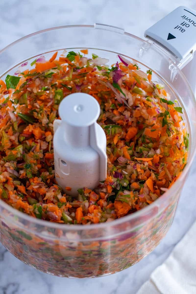 Red onions, carrots and celery in a food processor