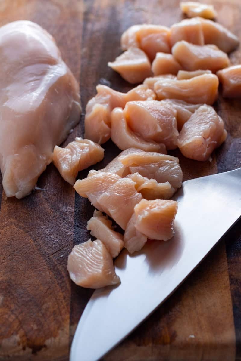 Diced chicken breast on a board.