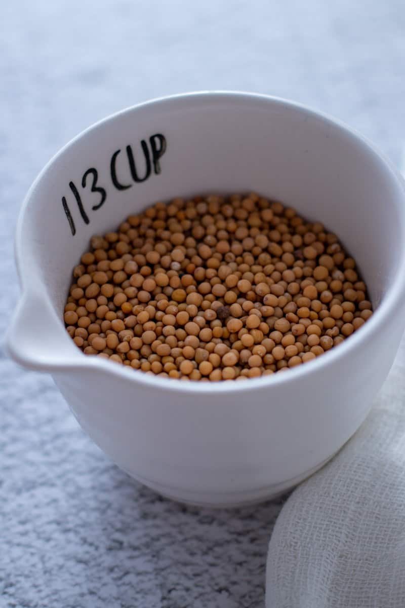 Mustard seeds in a measuring cup