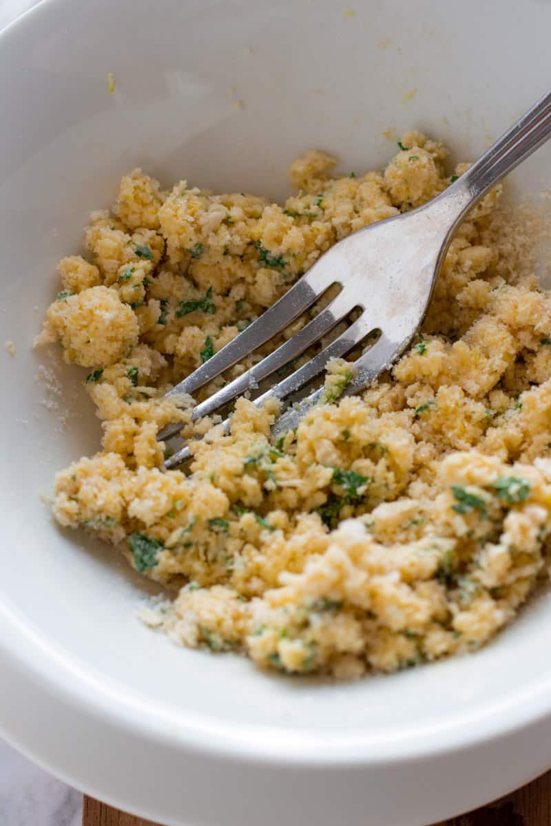 Parmesan, parsley, lemon zest and bread crumbs in a bowl.