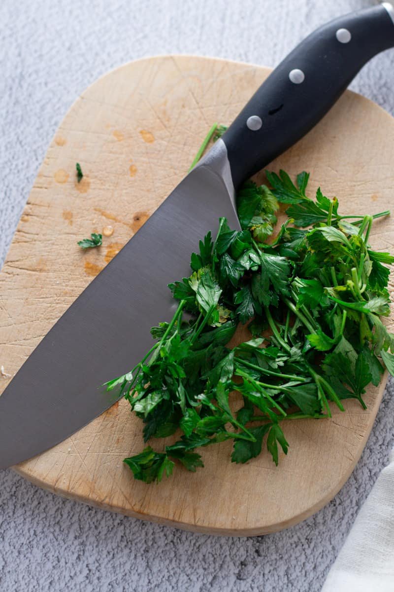 Chopped parsley with a kitchen knife.
