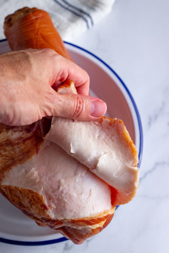 Peeling off ham skin.
