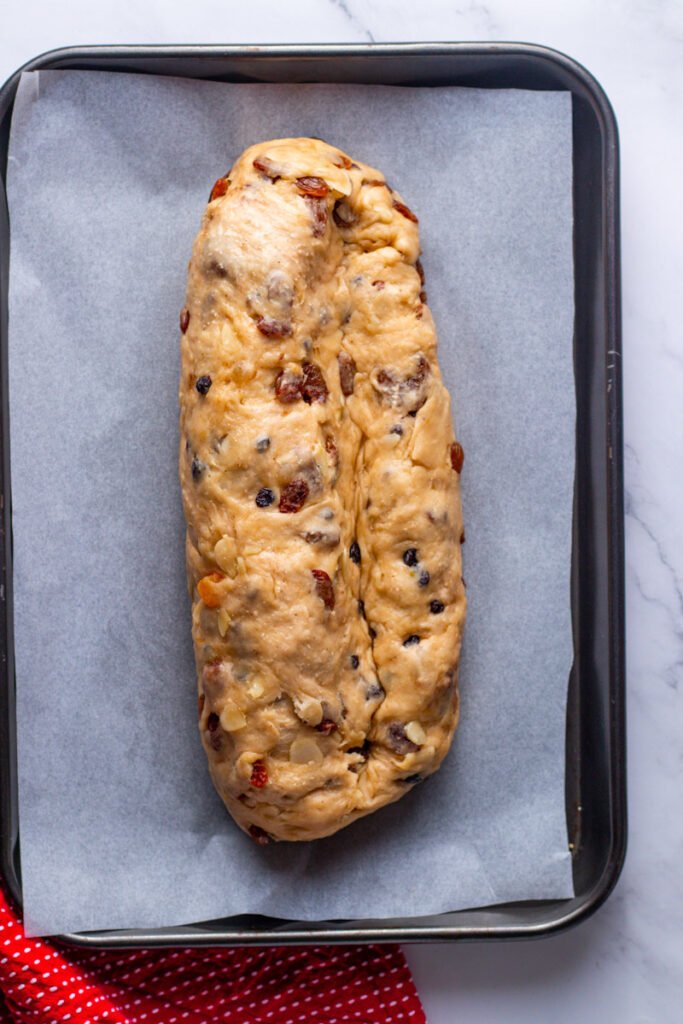 Folded Stollen dough in traditional shape.