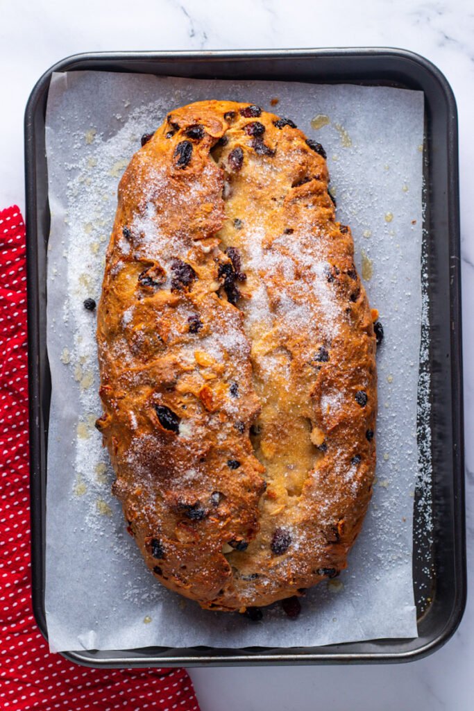 Freshly baked Stollen on a baking tray.