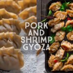 Pork and Shrimp Gyoza on a tray with spicy dipping sauce and fresh herbs. Title Card.