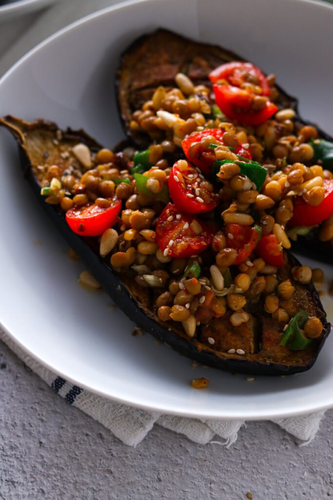 Roasted Eggplants stiffed with lentils in a bowl.