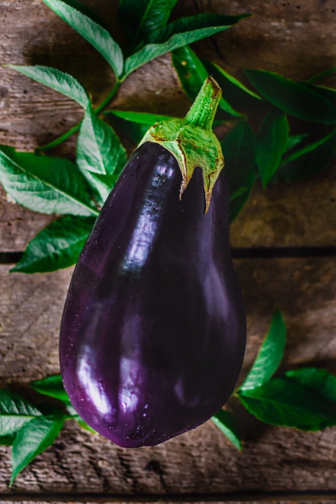 An eggplant on a wooden background.