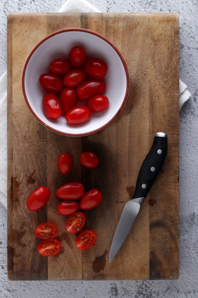 Cherry tomatoes on a chopping board.