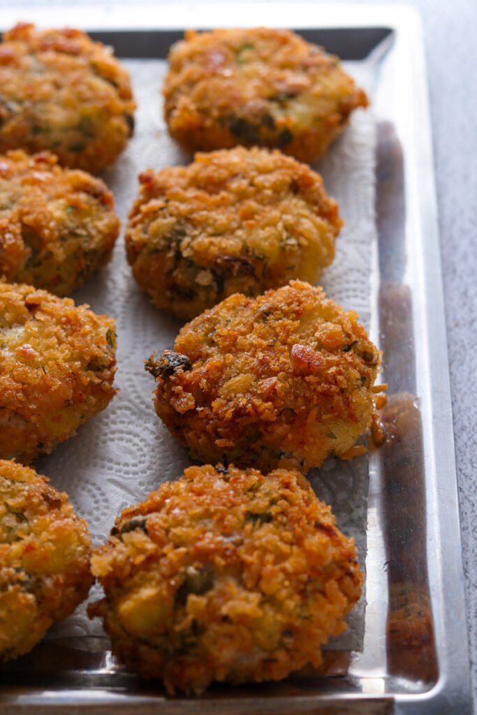 Cooked Salmon Cakes on a tray.