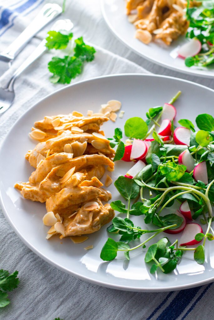 Coronation Chicken with salad on a plate.