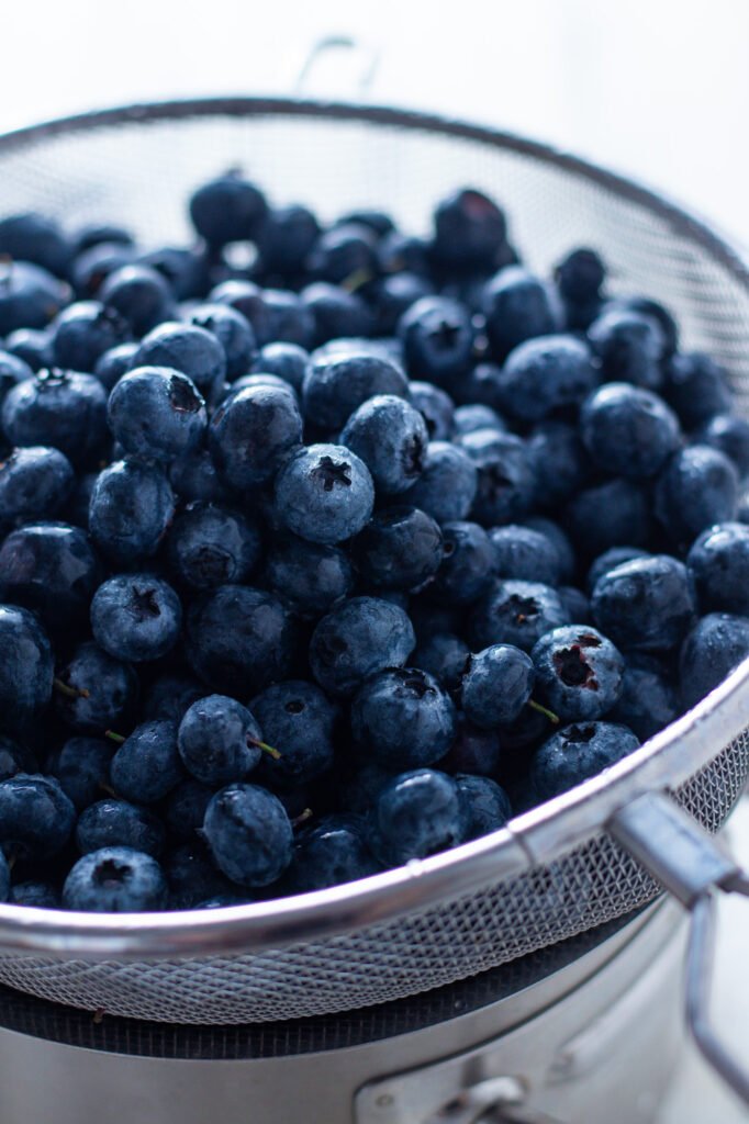 Fresh blueberries in a sieve.
