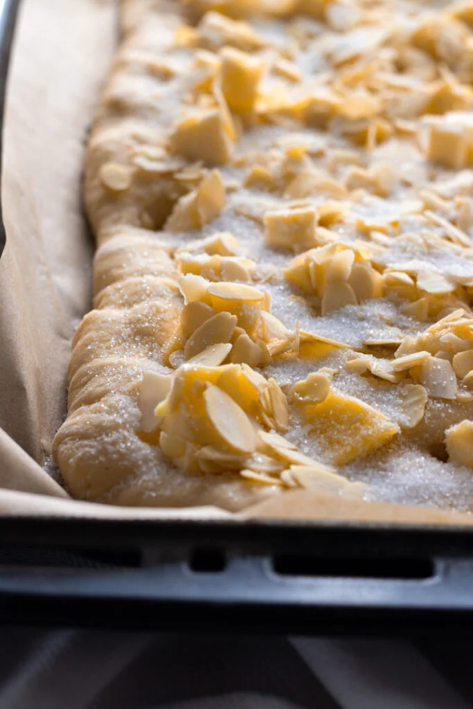 Sugar, almonds and butter on butterkuchen dough.