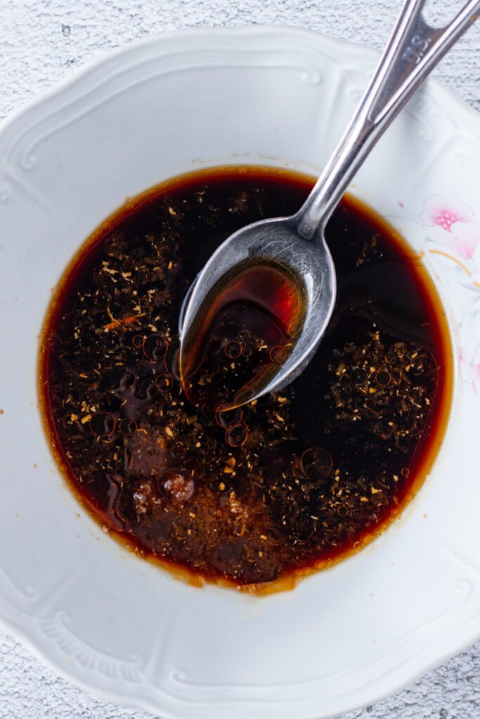 Homemade Teriyaki Sauce in a bowl with a measuring spoon.