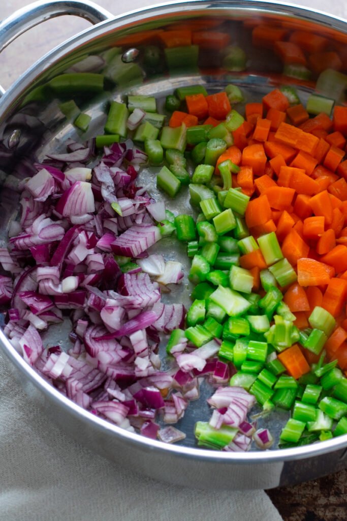 Red onion, celery and carrot in a pan.
