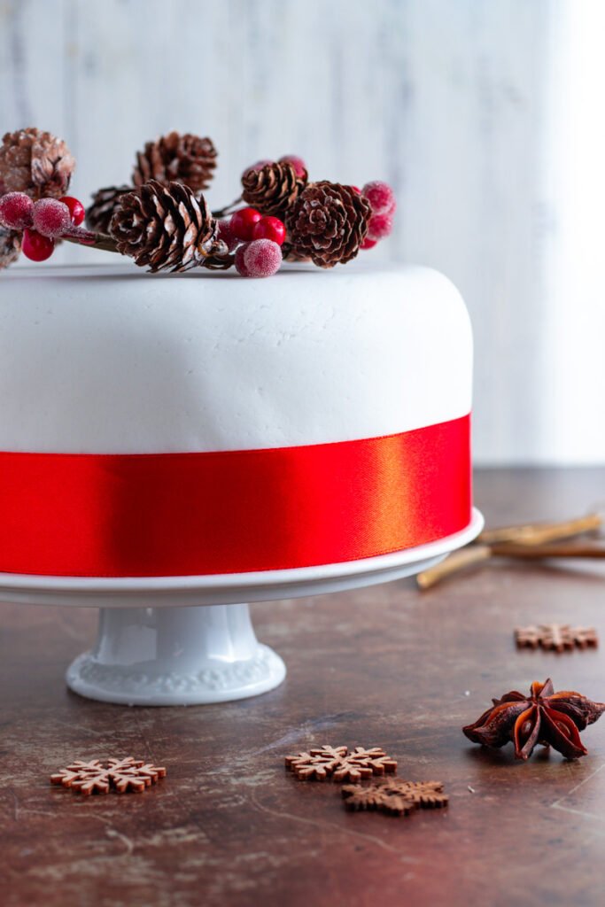 Christmas cake wrapped with red ribbon.