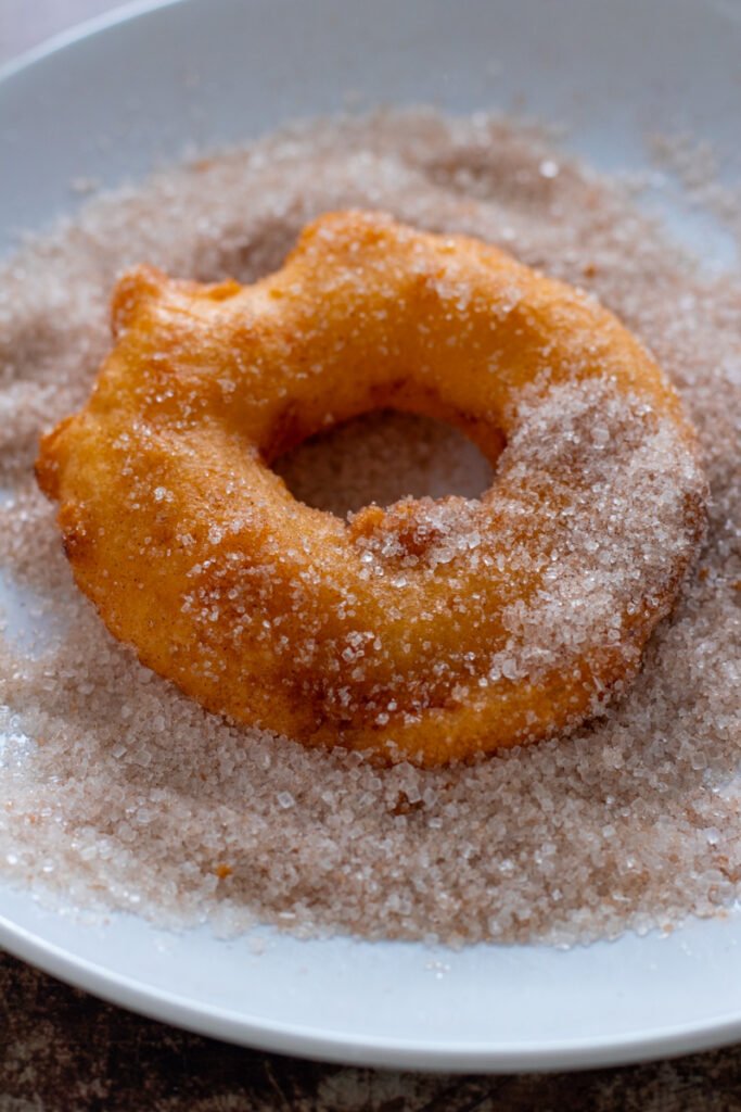 A deep fried apple ring in cinnamon sugar.
