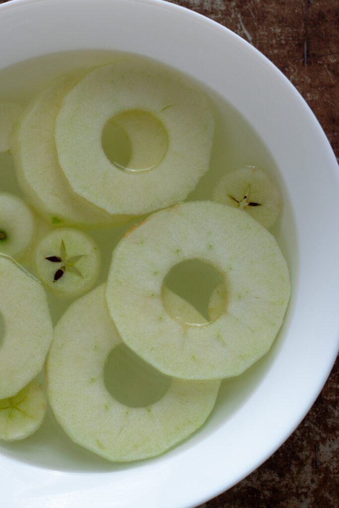 Apple rings in a bowl of lemon water.