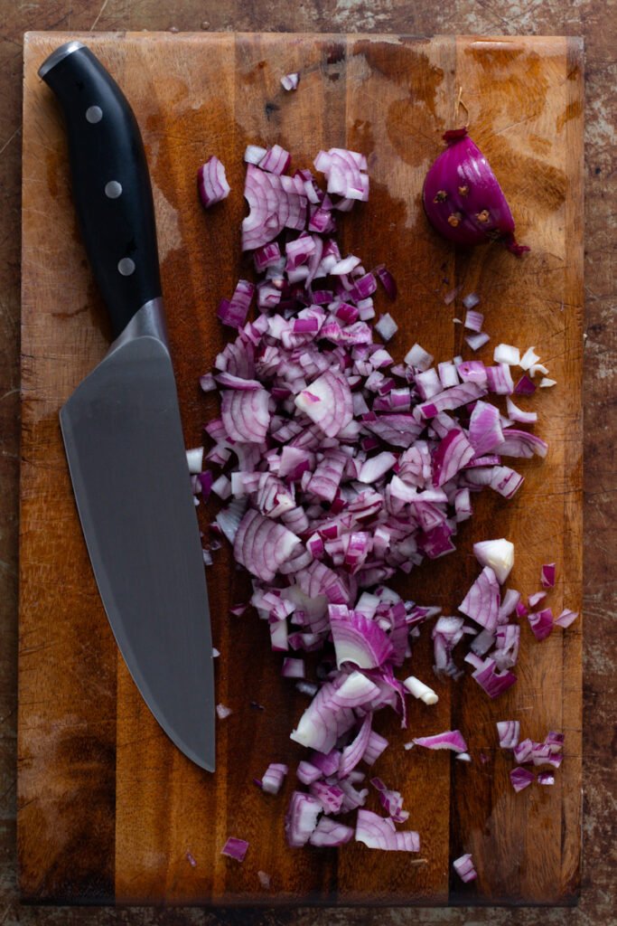 Diced red onions with a kitchen knife.