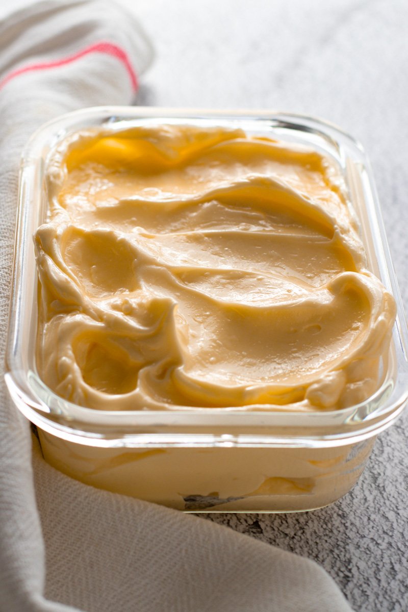 A glass dish of spreadable butter.