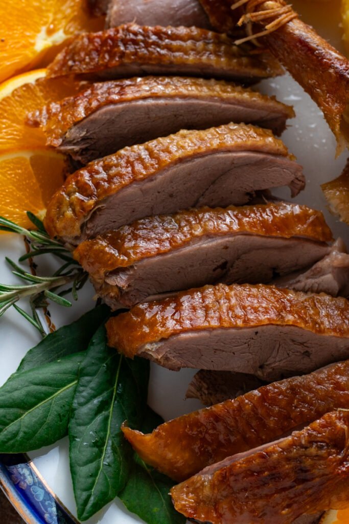 Sliced roast goose on a plate.